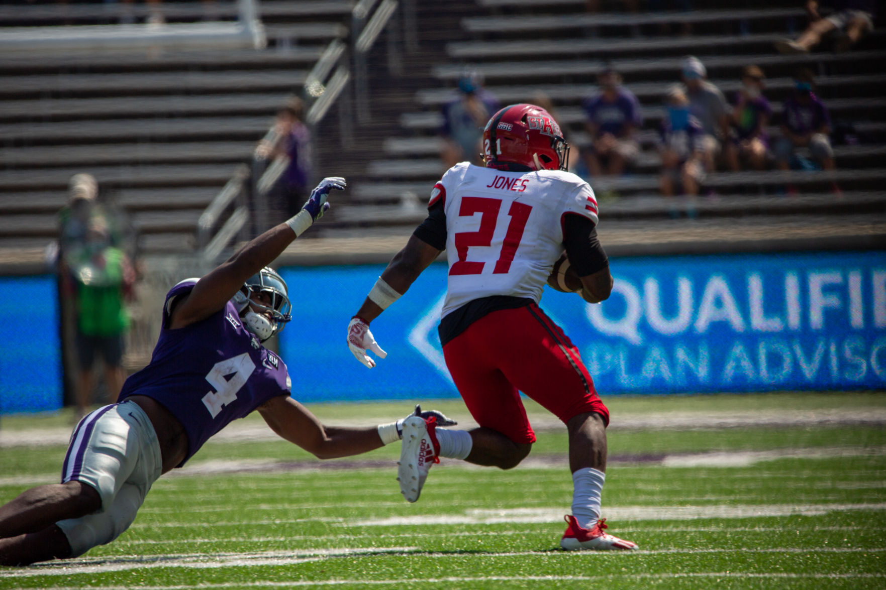 Wayne Jones, sophomore defensive back, reaches out for Jamal Jones, senior running back. The Kansas State Wildcats faced off against Arkansas State wolves on Saturday at Bill Snyder Family Stadium, Arkansas State beat Kansas State 35 to 31.